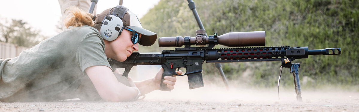 competitive shooting aiming rifle while in a prone position